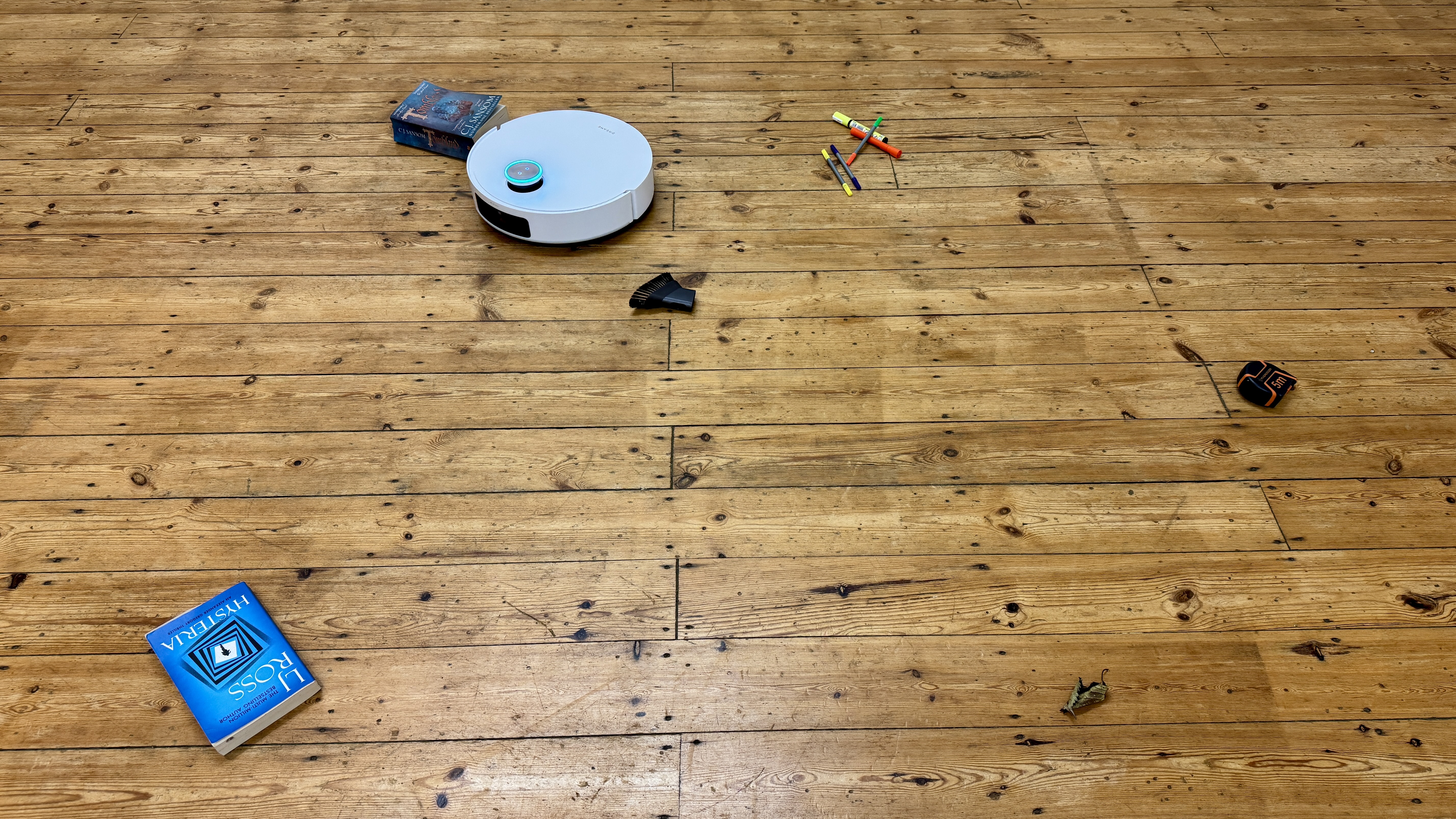 Dreame Matrix10 Ultra robot vacuum navigating around obstacles on a wooden floor