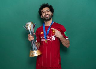 Mohamed Salah of Liverpool poses with the Club World Cup trophy after the FIFA Club World Cup Qatar 2019 Final match between Liverpool and CR Flamengo at Khalifa International Stadium on December 21, 2019 in Doha, Qatar.