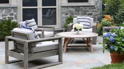 Small backyard with grey painted patio furniture