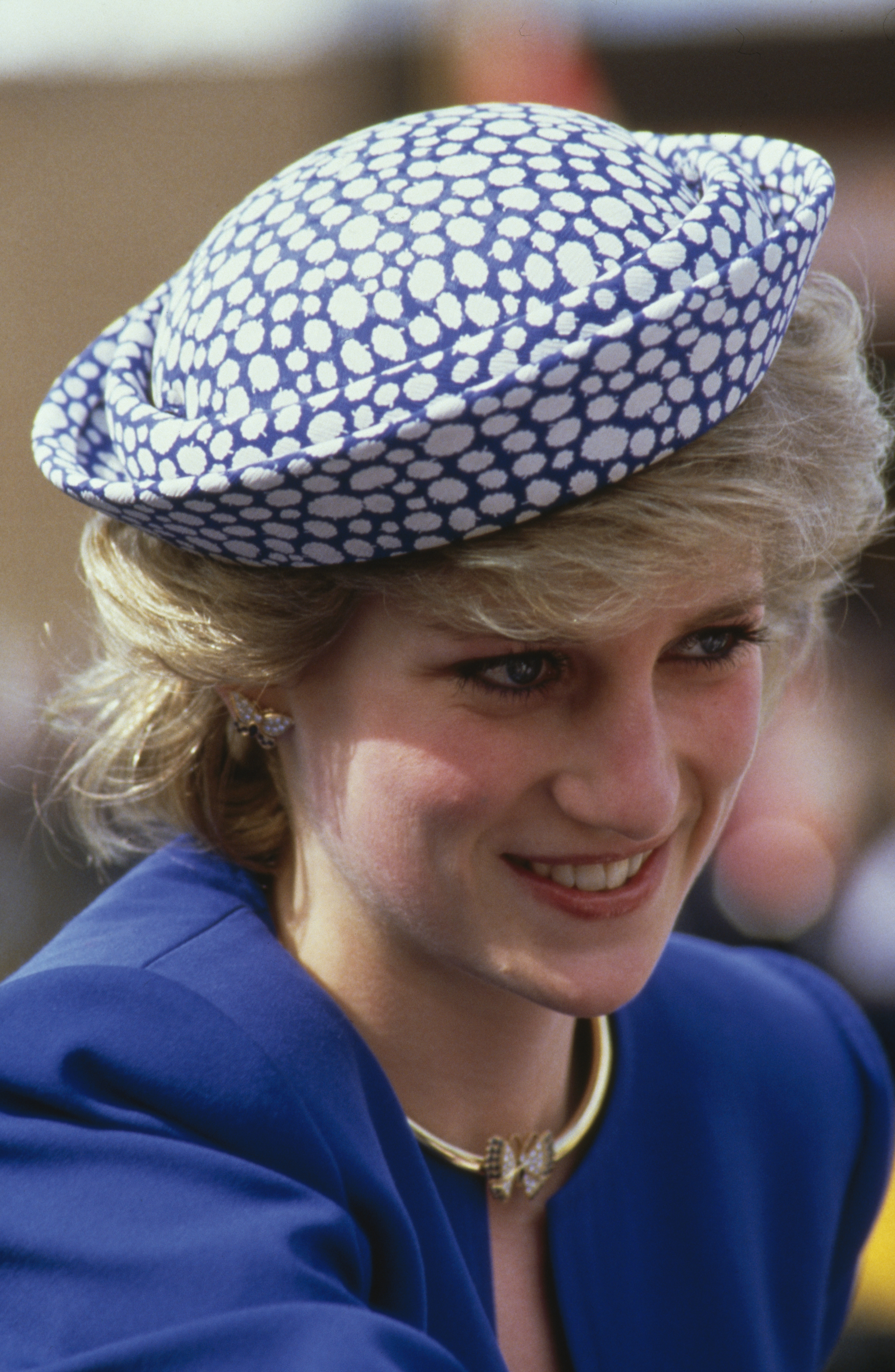 Princess Diana wearing a blue jacket and spotted hat