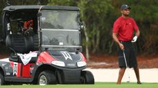 Tiger Woods playing in The Match with his golf buggy