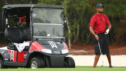 Tiger Woods playing in The Match with his golf buggy