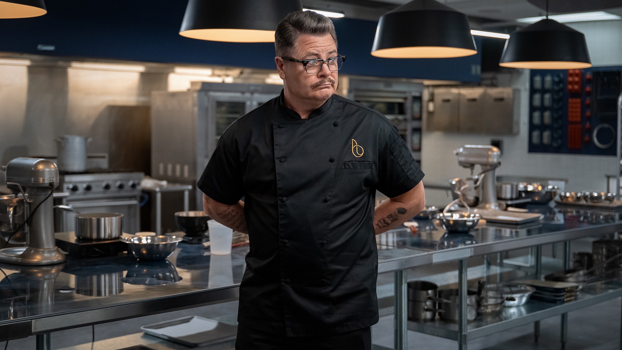 Nick Offerman in a chef's uniform in the kitchen in Voicemails for Isabelle
