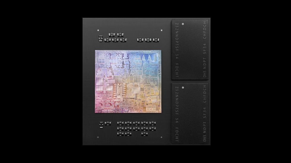 Apple&amp;#039;s M1 chip, a semiconductor with a series of markings on it and a ranbow-coloured main plate, on black background