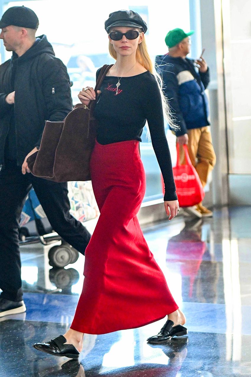 Anya Taylor-Joy wearing a red maxi skirt at the airport