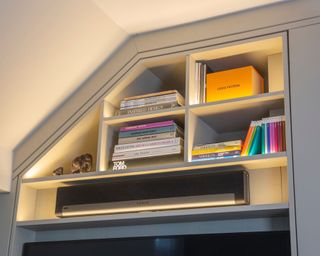 Bookshelf showing a soundbar mounted onto the wall