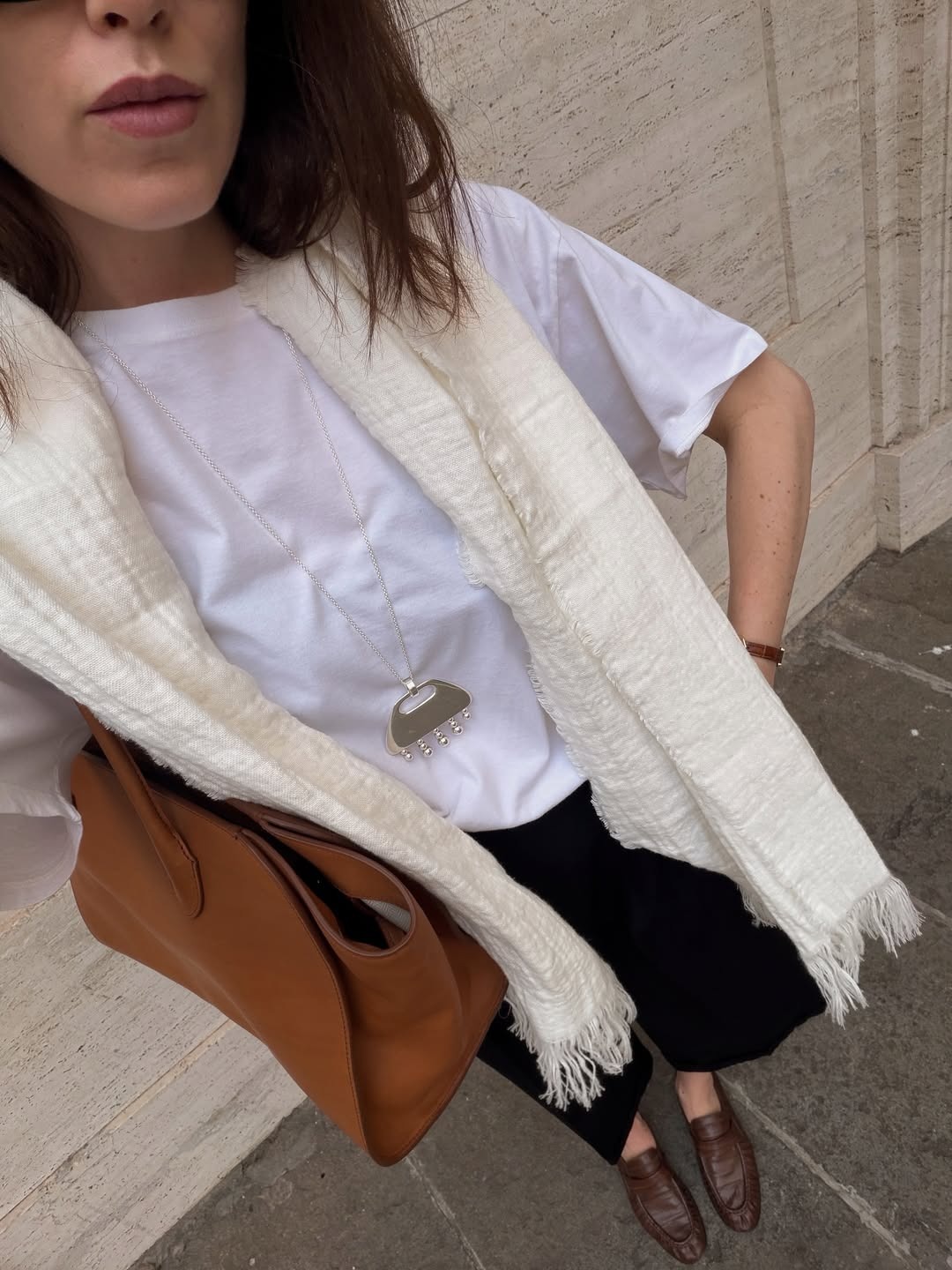 Influencer wearing a silver pendant necklace.