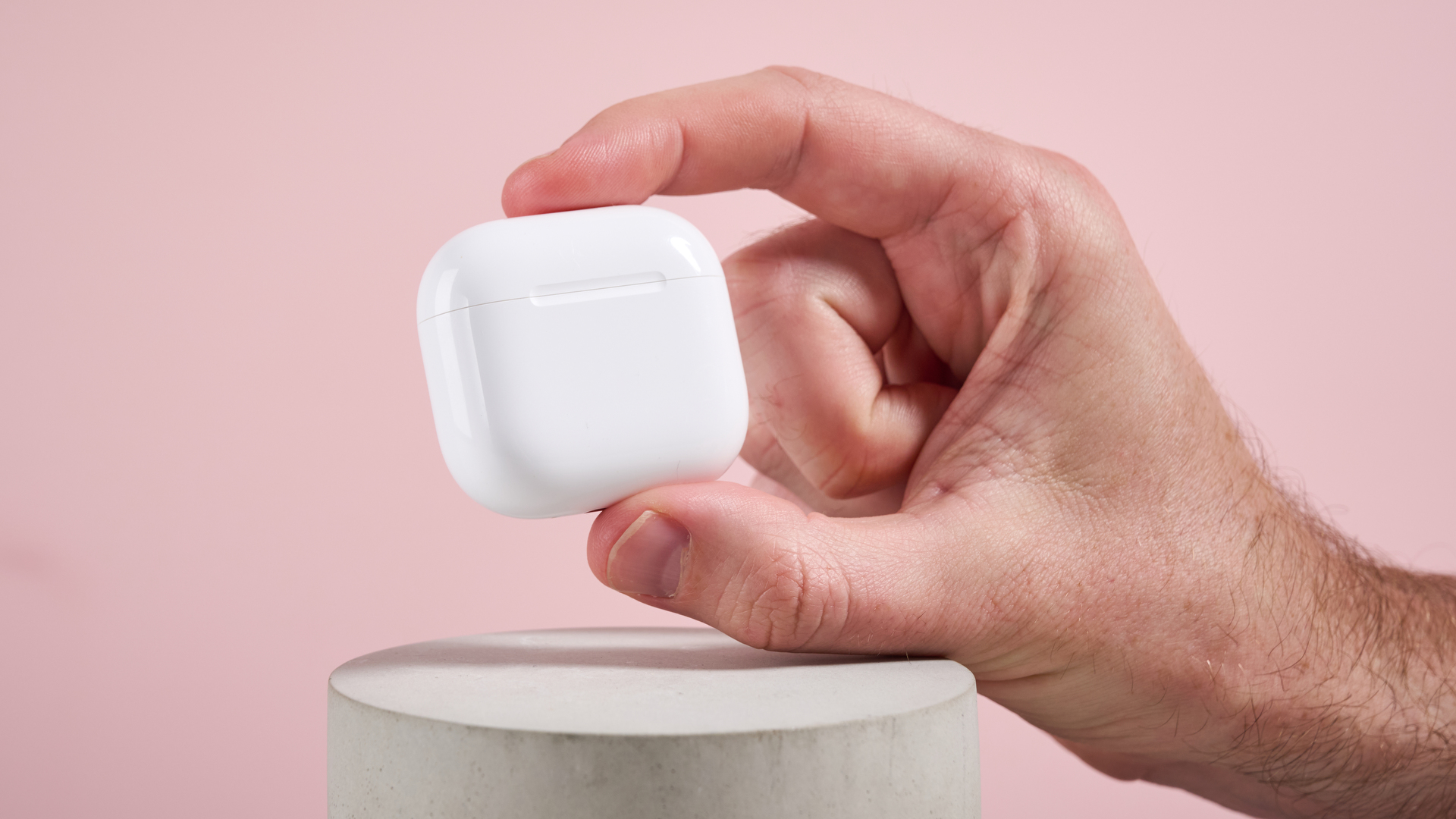 AirPods 4 with Active Noise Cancellation case held in a man's hand