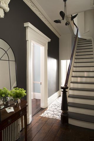 dark painted hallway with timber staircase