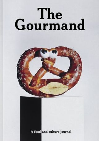 The Gourmand tries to crack a smile with their cover design