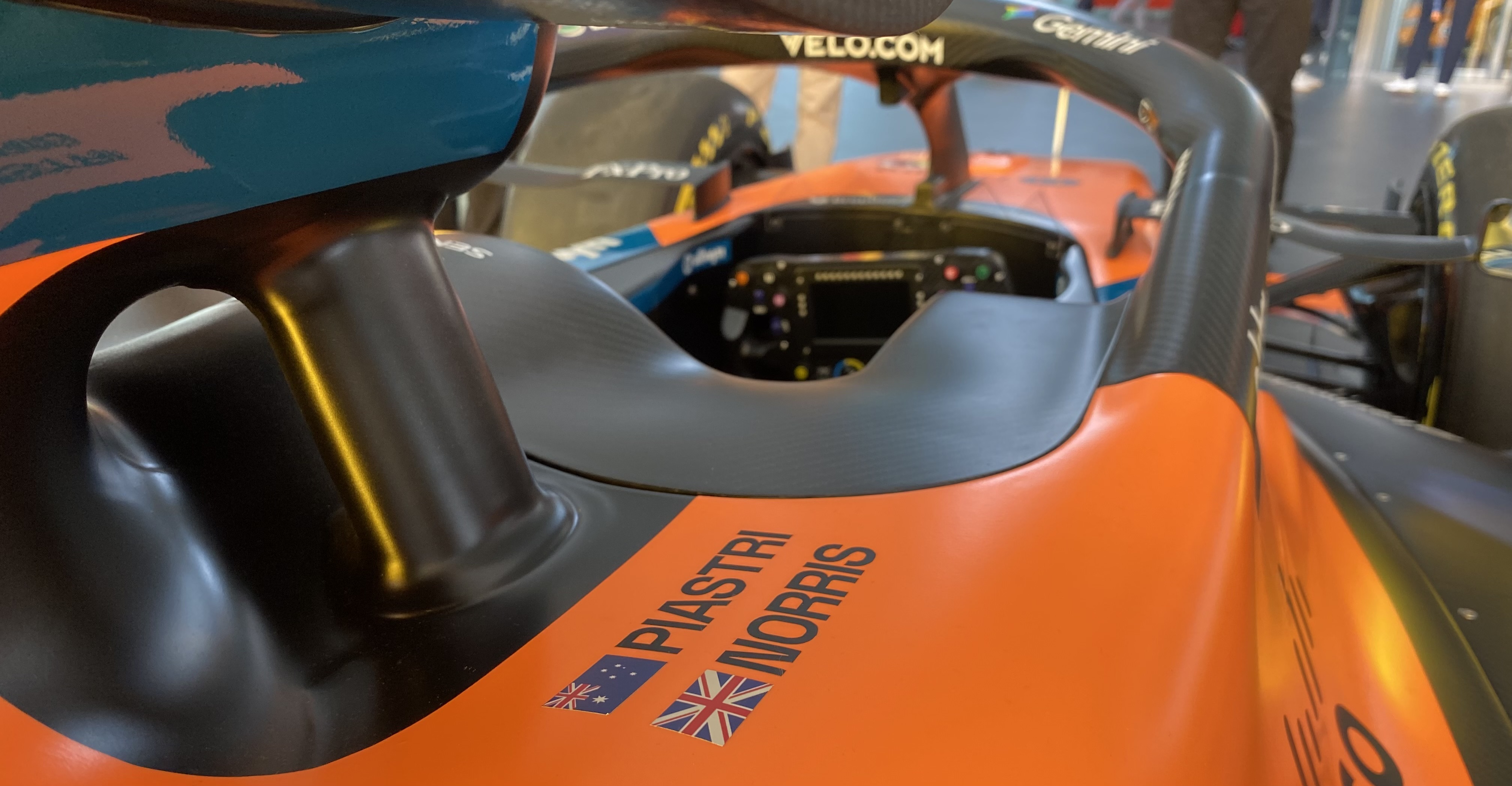 A photo looking through the Halo of a McLaren Formula 1 car, with Piastri and Norris' names and flags of origin visible
