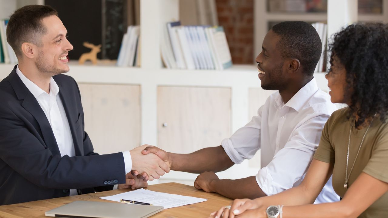 An accountant meets with clients in an office.