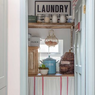 small pantry and laundry room with wall shelf and cupboard skirt