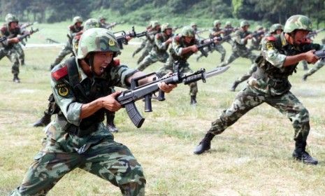 Chinese paramilitary policemen exercise during a training session in Wuxi city: The government announced a 11.2 percent boost in military spending this year.