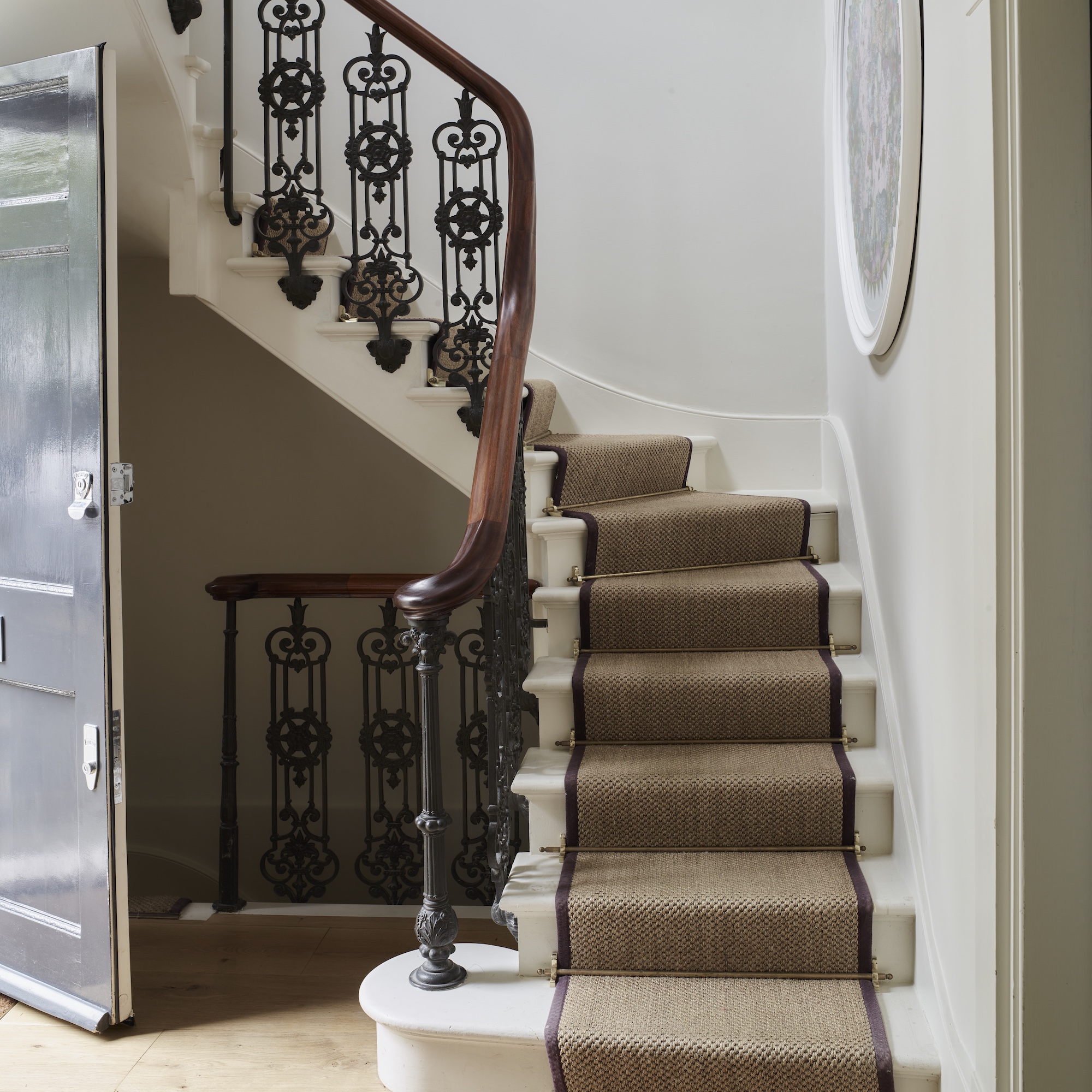 stairway in georgian townhouse with metal bannisters and stair runner