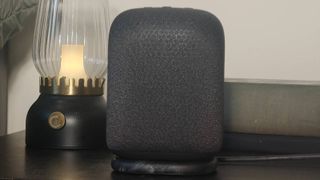 The Sony LinkBuds Speaker on a shelf beside a bed.