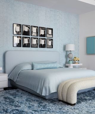 Bedroom with light blue bed and walls and pictures on the wall