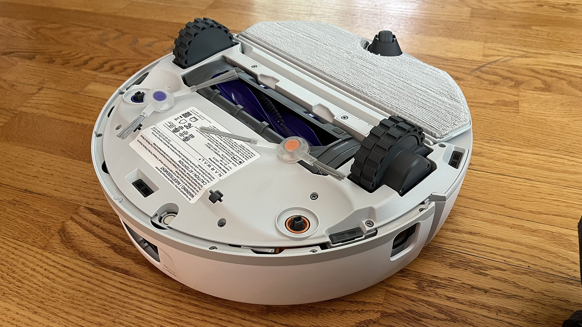 Narwal Freo X Plus robot vacuum and mop flipped over to show underside