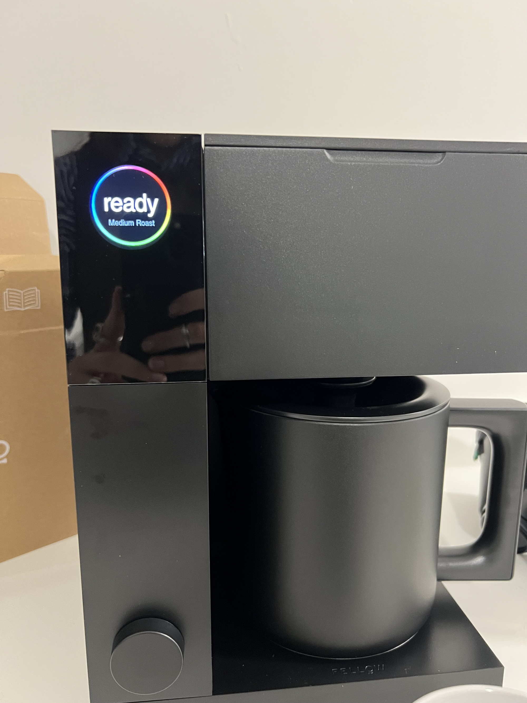 Close up of the Fellow Aiden Precision coffee maker in black with the ready sign glowing