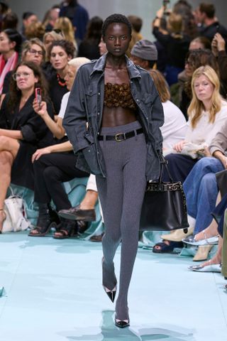 a Prada model walks the spring/summer 2025 runway in skinny leggings