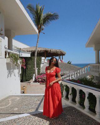 Woman wearing a red maxi dress.