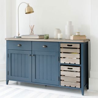 blue cabinet with books and white wall
