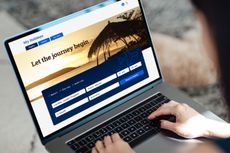 Woman using laptop to book flight tickets and plan holiday