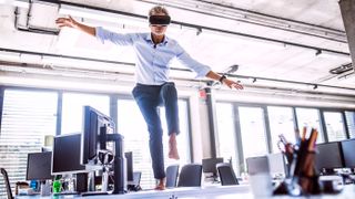 Man standing on desk in VR. 