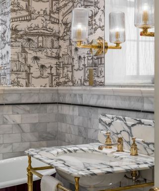 An example of gray bathroom tile ideas with a marble sink and tiles by Drummonds
