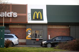 Long queues outside a McDonald's restaurant and drive thru prior to closure on March 23, 2020 in Weymouth, United Kingdom.