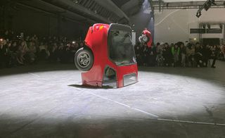 Abloh’s glamorous girl gang strutted around a series of red Mercedez, sawn in two and installed as sculptures on the runway, sporting the brands signature hybrid silhouettes