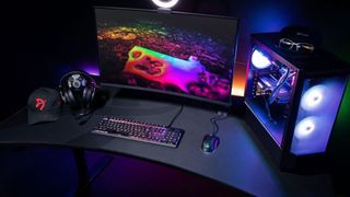 Arozzi Arena Ultrawide gaming desk with monitor, PC, and hat in dark room