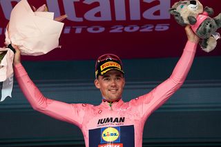 Stage winner Lidl-Trek's Danish rider Mads Pedersen wearing the overall leader's pink jersey (Maglia Rosa) celebrates on the podium after the 3rd stage of the 108th Giro d'Italia cycling race, 160km from Vlore to Vlore in Albania, on May 11, 2025. (Photo by Luca Bettini / AFP)