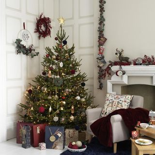 panelled wall in white living room with gift bags under decorated Christmas tree