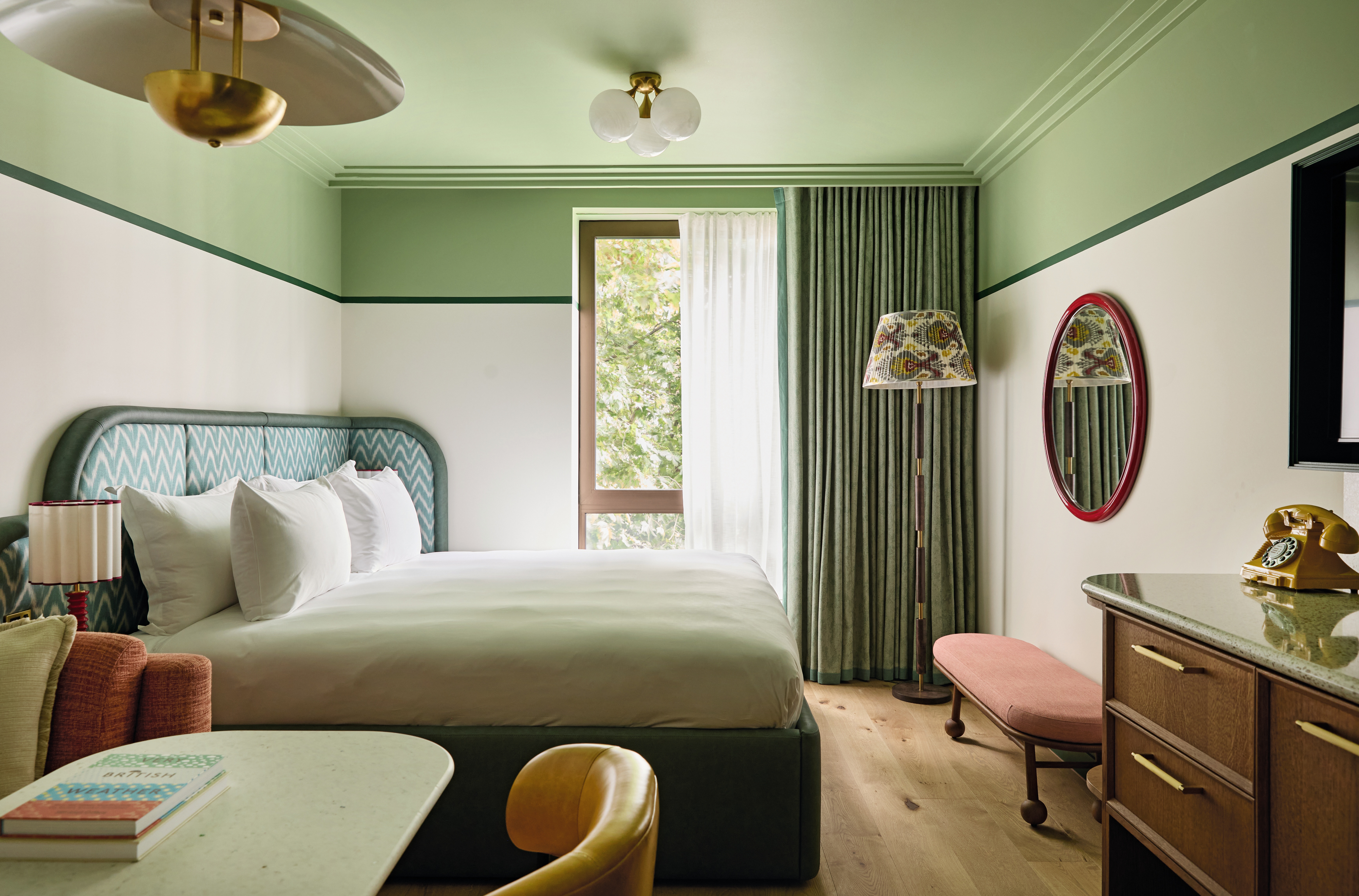 A mint-green-tinted hotel room with sculptural interiors, Art Deco lighting, and quirky textiles.