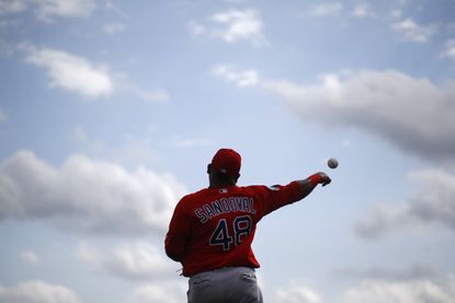Boston Red Sox third baseman Pablo Sandoval throws a ball during a spring training baseball workout in Fort Myers, Florida.