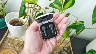 Reviewer holding Amazon Echo Buds in charging case