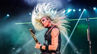 Nita Strauss performs with Alice Coopers on stage at Resorts World Arena on May 30, 2022 in Birmingham, England.