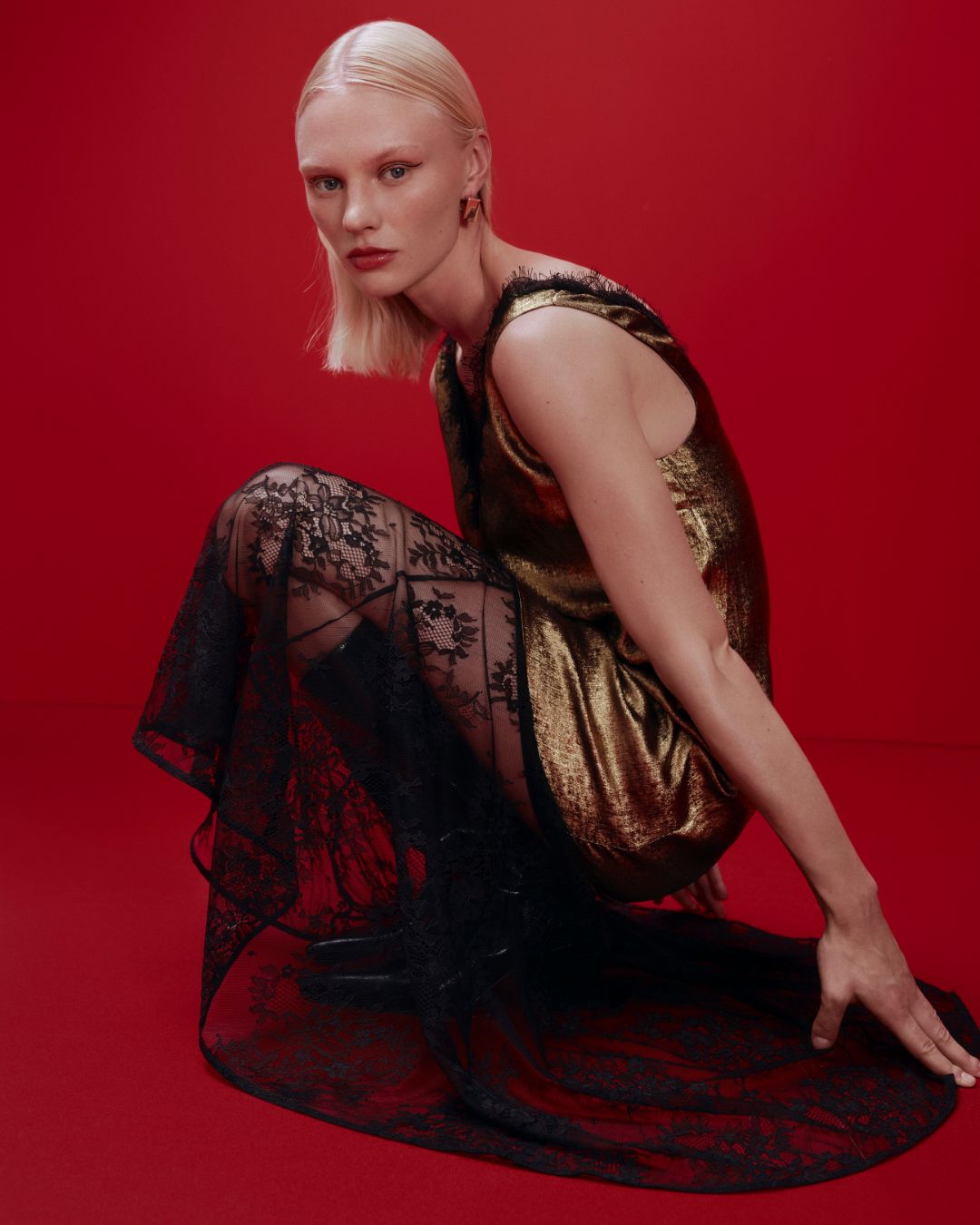 a model wears a gold and black lace dress from M&amp;amp;S