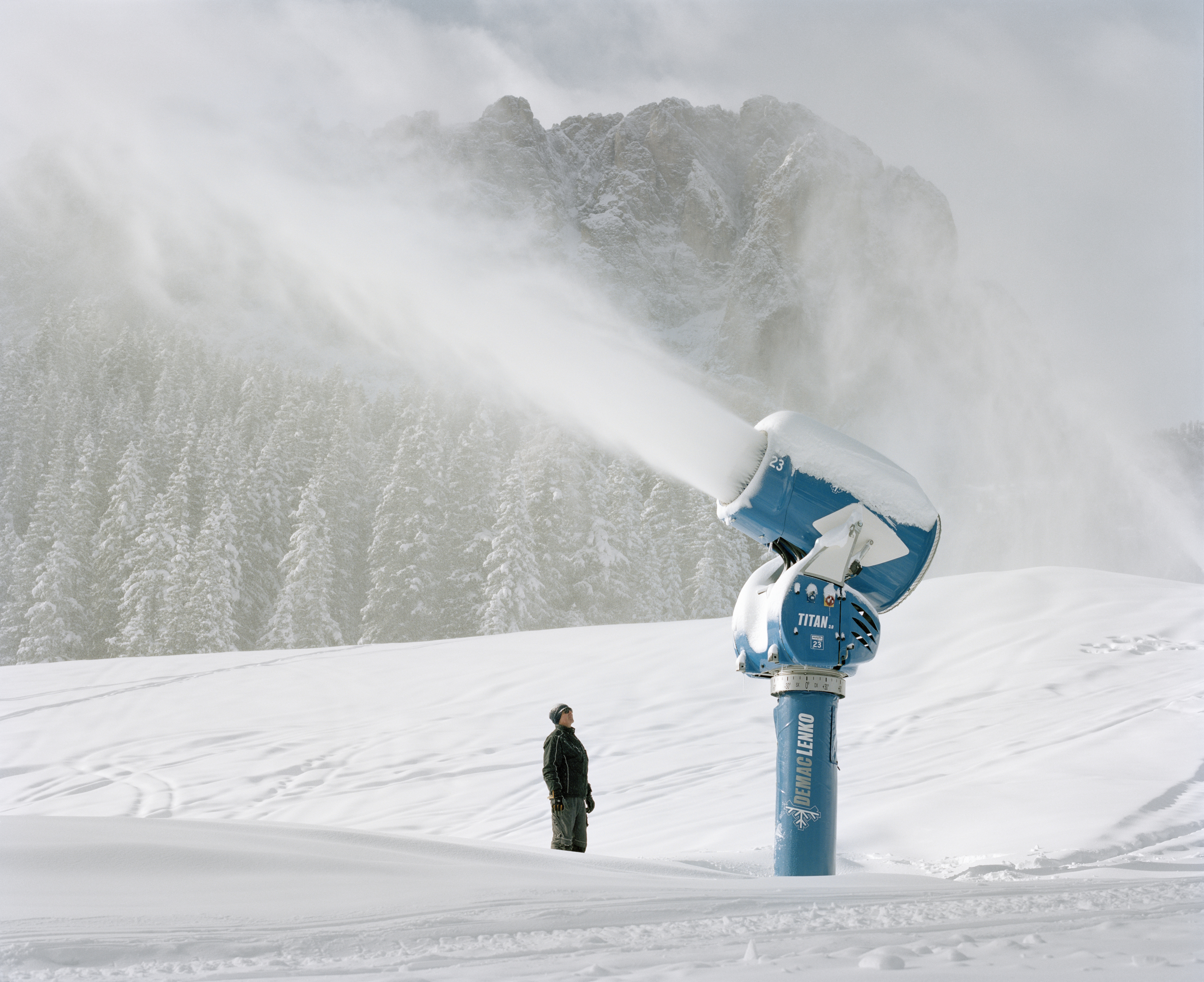 Snow cannon producing artificial snow. Dolomites ski resort. Italy