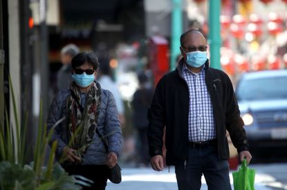 People wear face masks in San Francisco.