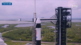 A black and white Crew-9 rocket sands on its launch pad under clouds on Sept. 28, 2024.