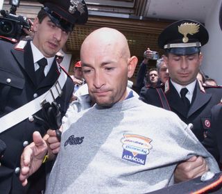 Marco Pantani escorted by the carabinieri from his hotel on Madonna di Campiglio in 1999