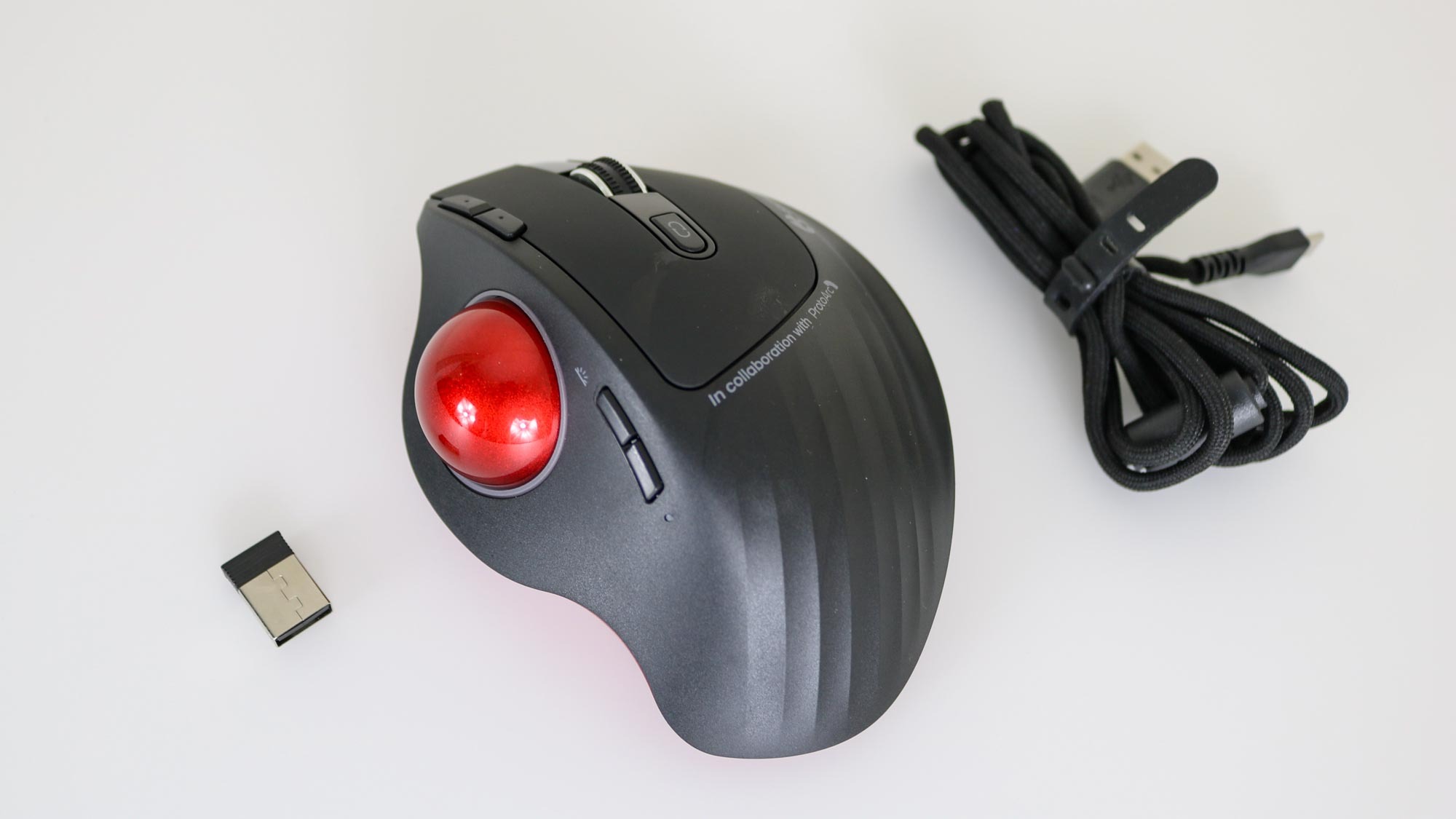 The GameBall Thumb trackball next to all of the accessories it comes with