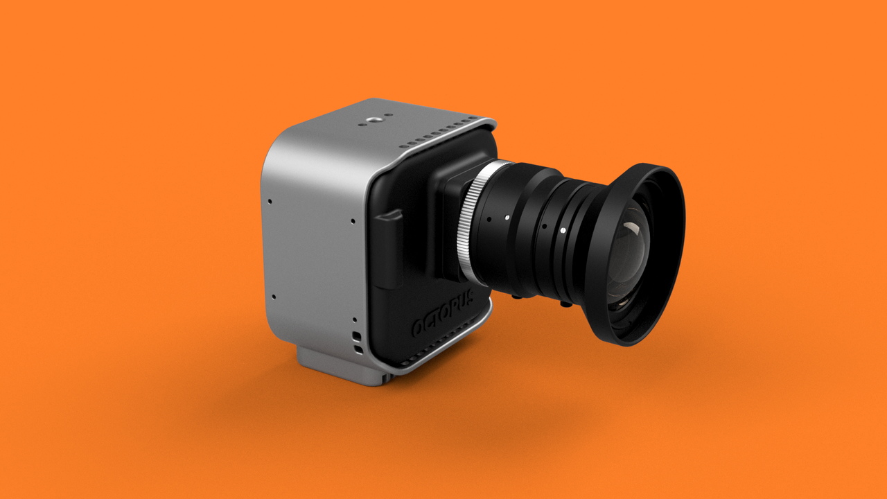 Octopus Cinema 16 cine camera on orange background with lens attached