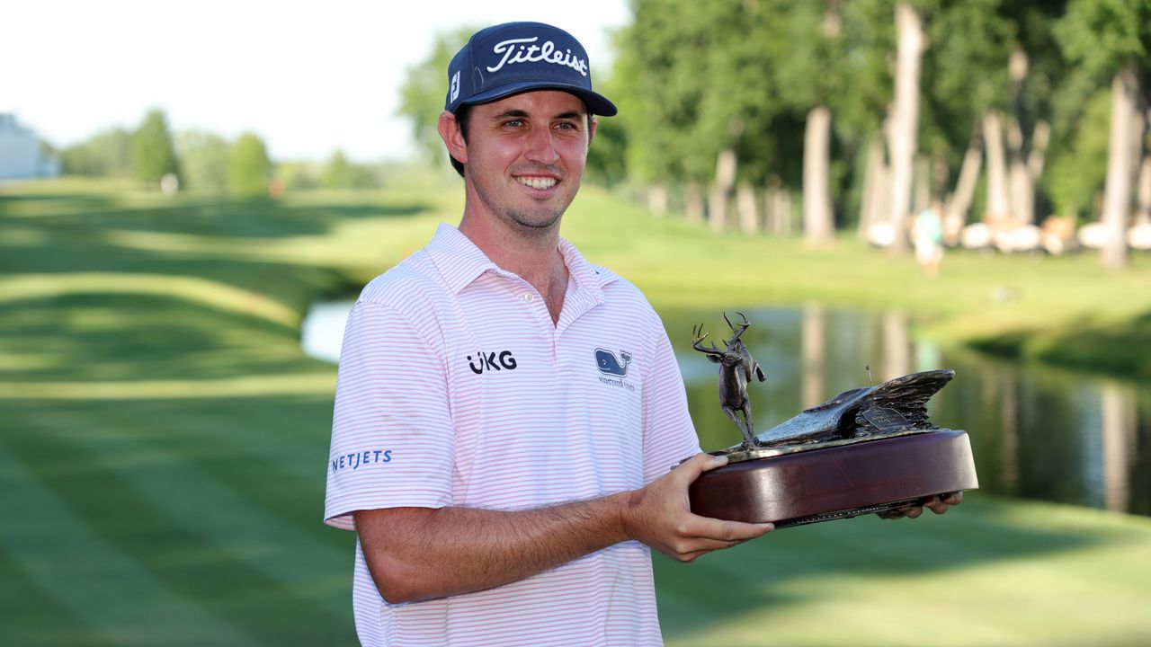 JT Poston lifting a trophy after winning the John Deere Classic in 2022