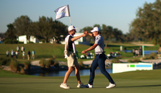 Maverick McNealy hugs his caddie