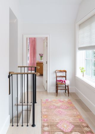 Landing with white walls and patterned runner on the floor