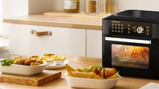 Proscenic T31 Air Fryer on a kitchen counter, surrounded by air fried food.