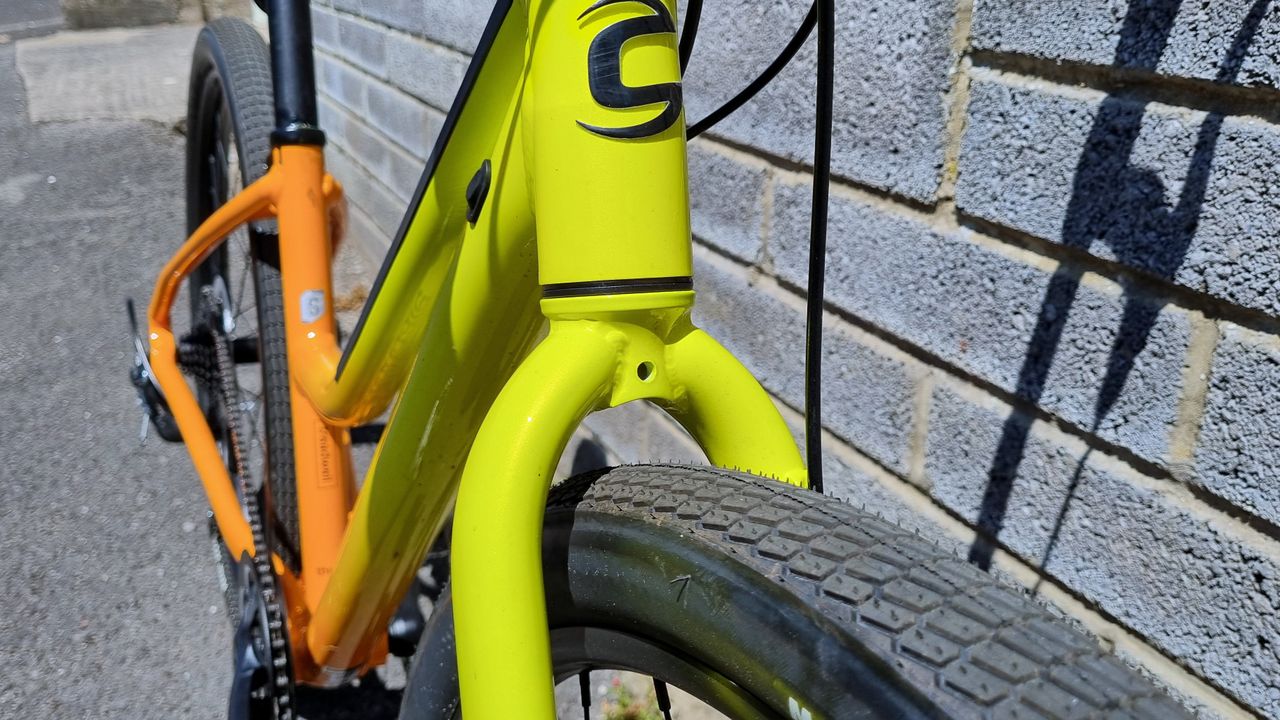 A close up of a mudguard mount on a yellow fork
